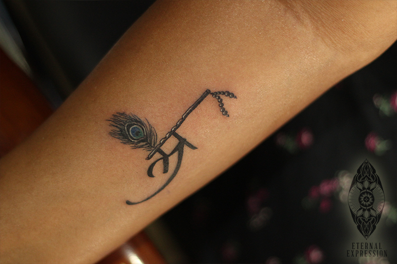 lord krishna tattoo with flute and peacock feather
