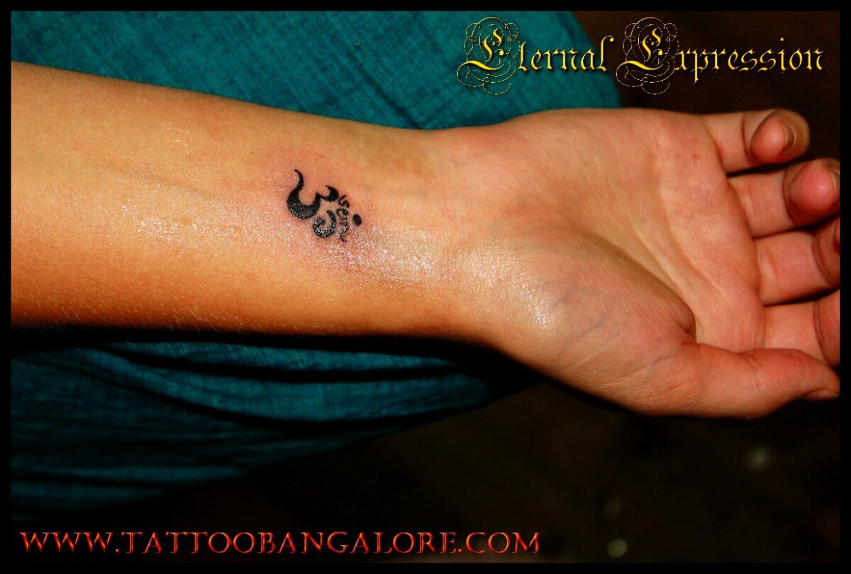 Om tattoo on hand - Om wrist tattoo for girls at the Best Tattoo Studio in Bangalore - Eternal Expression 